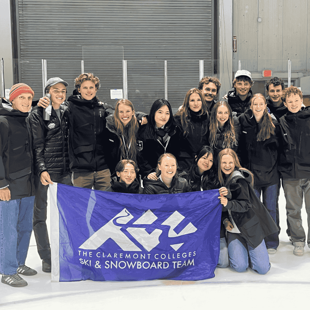 Ski and Snowboarding Team students post with a banner at nationals