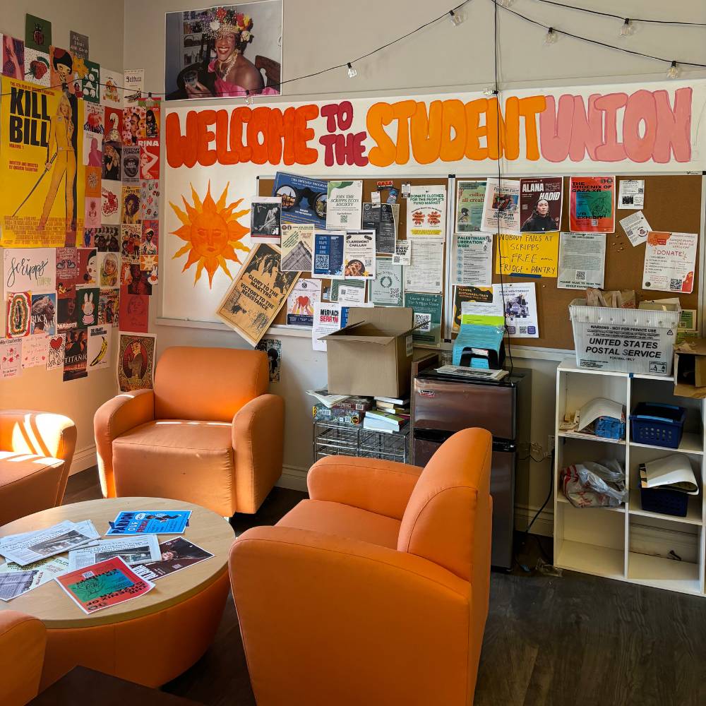 Orange chairs sit underneath a 
