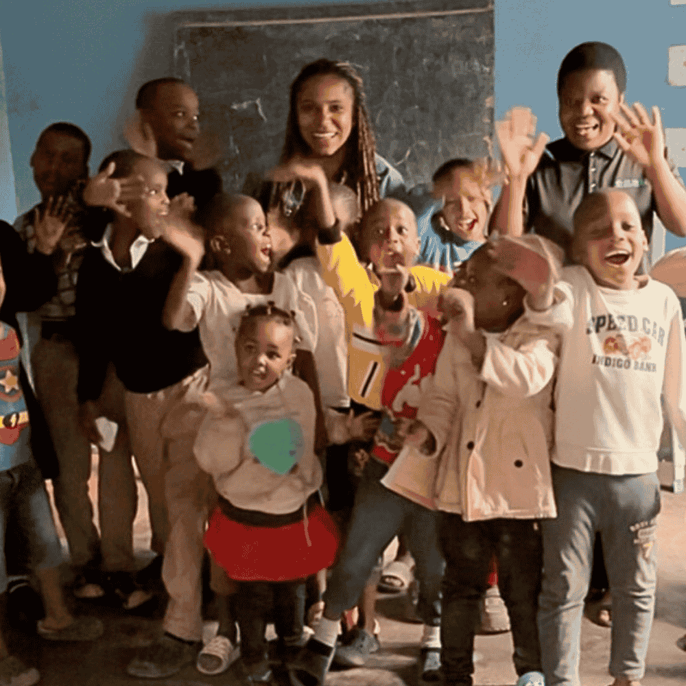 Talent Johnson with children in Tanzania