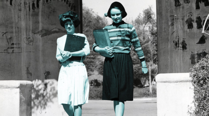 Student walking near graffiti wall